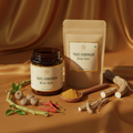 Ojas Vardhan herbal powder in dark glass jar with amalaki berries and ashwagandha root on rich gold silk surface