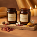 Dampati Ananda herbal powder in two dark glass jars with saffron, rose petals and jasmine on warm sandstone surface